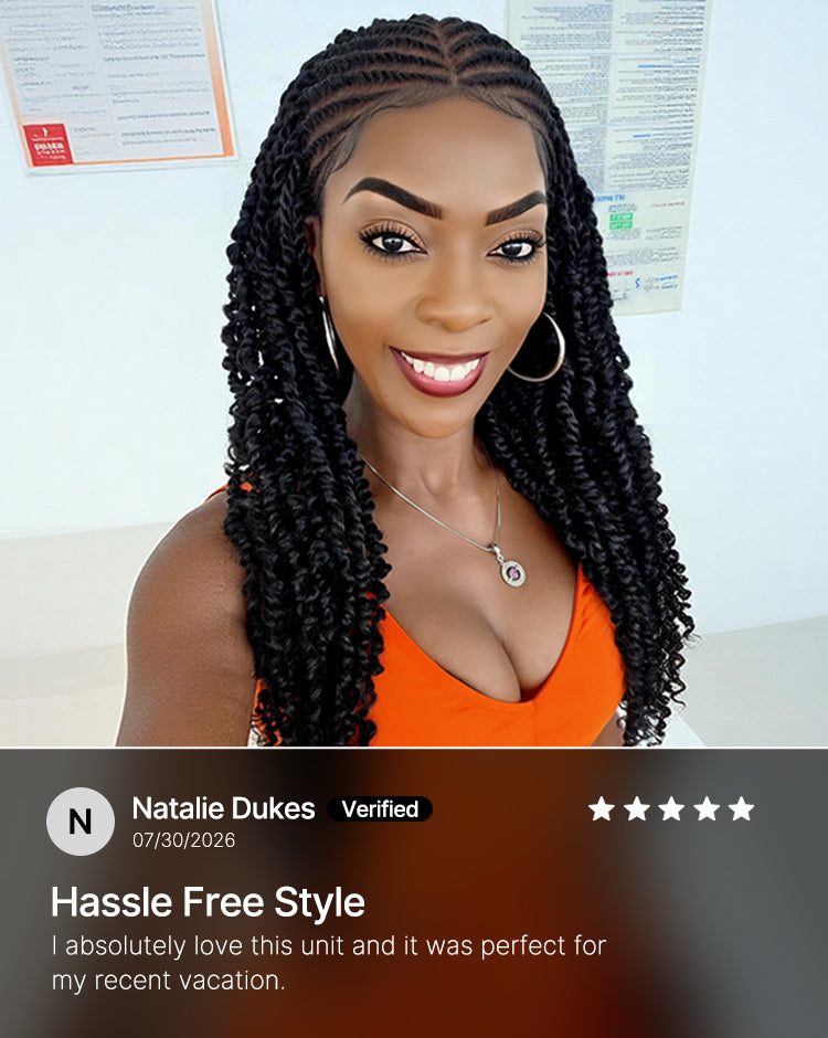 A smiling woman with long, dark, neatly styled twist braids or box braids is shown from the chest up against a light indoor wall with posters. She wears a bright orange top and silver hoop earrings.